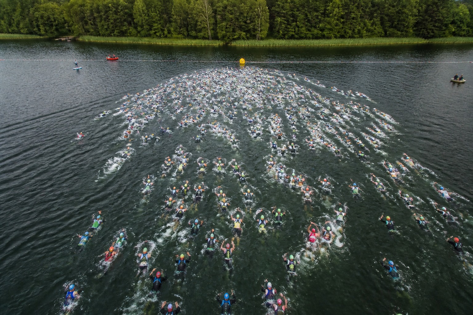 Triathletes treading water at a deep water swim start before a race