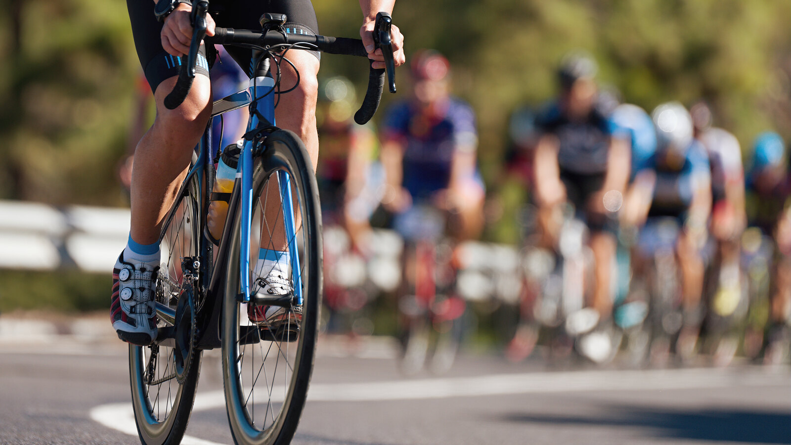 Group of road cyclists racing in close formation