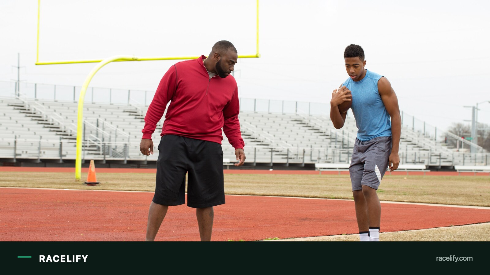Coach working with an athlete on the track