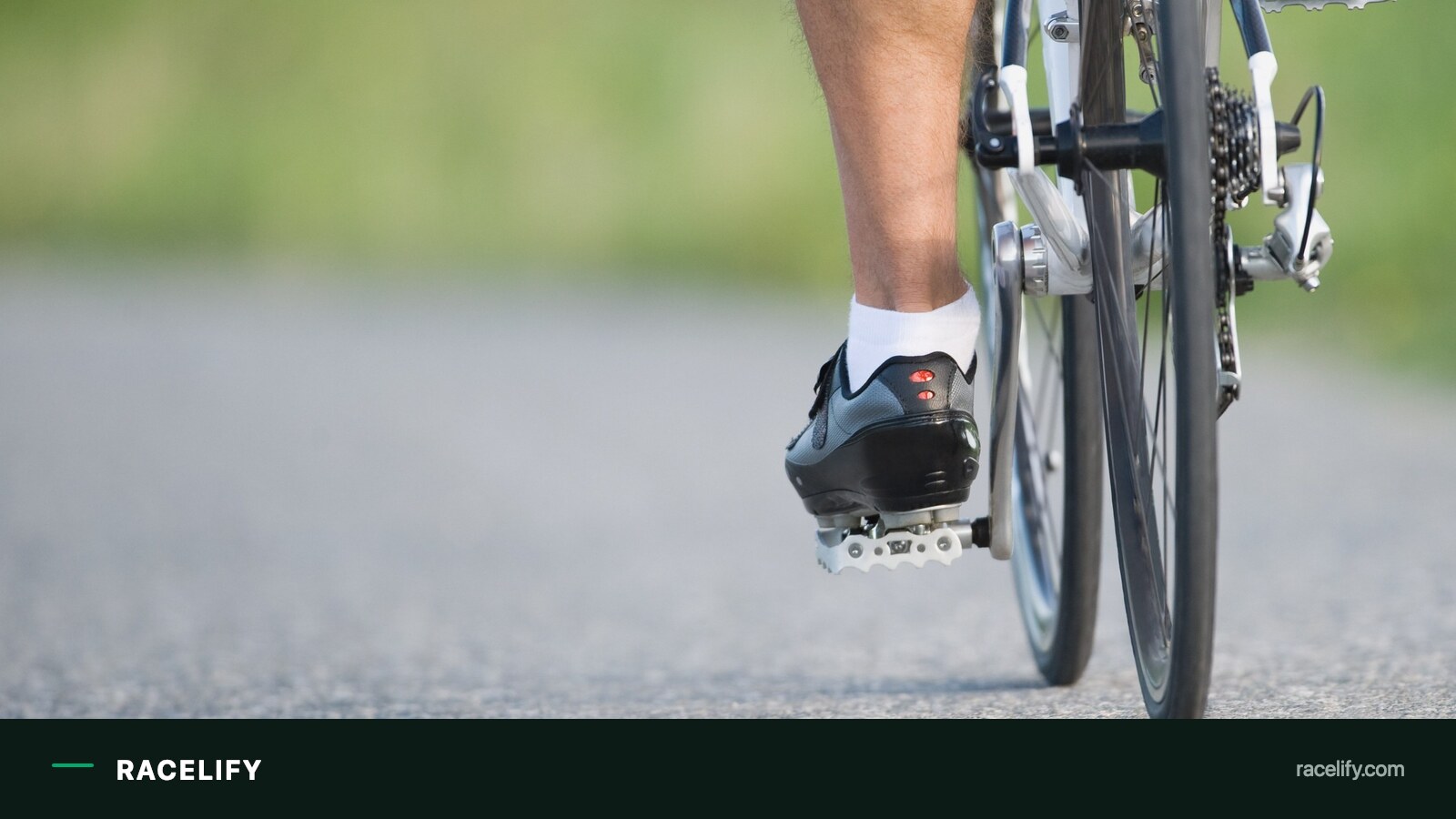 Cyclist's lower legs and feet turning the pedals