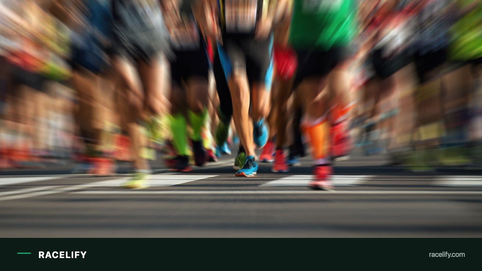 Blurred mass field of runners at the start of a road race