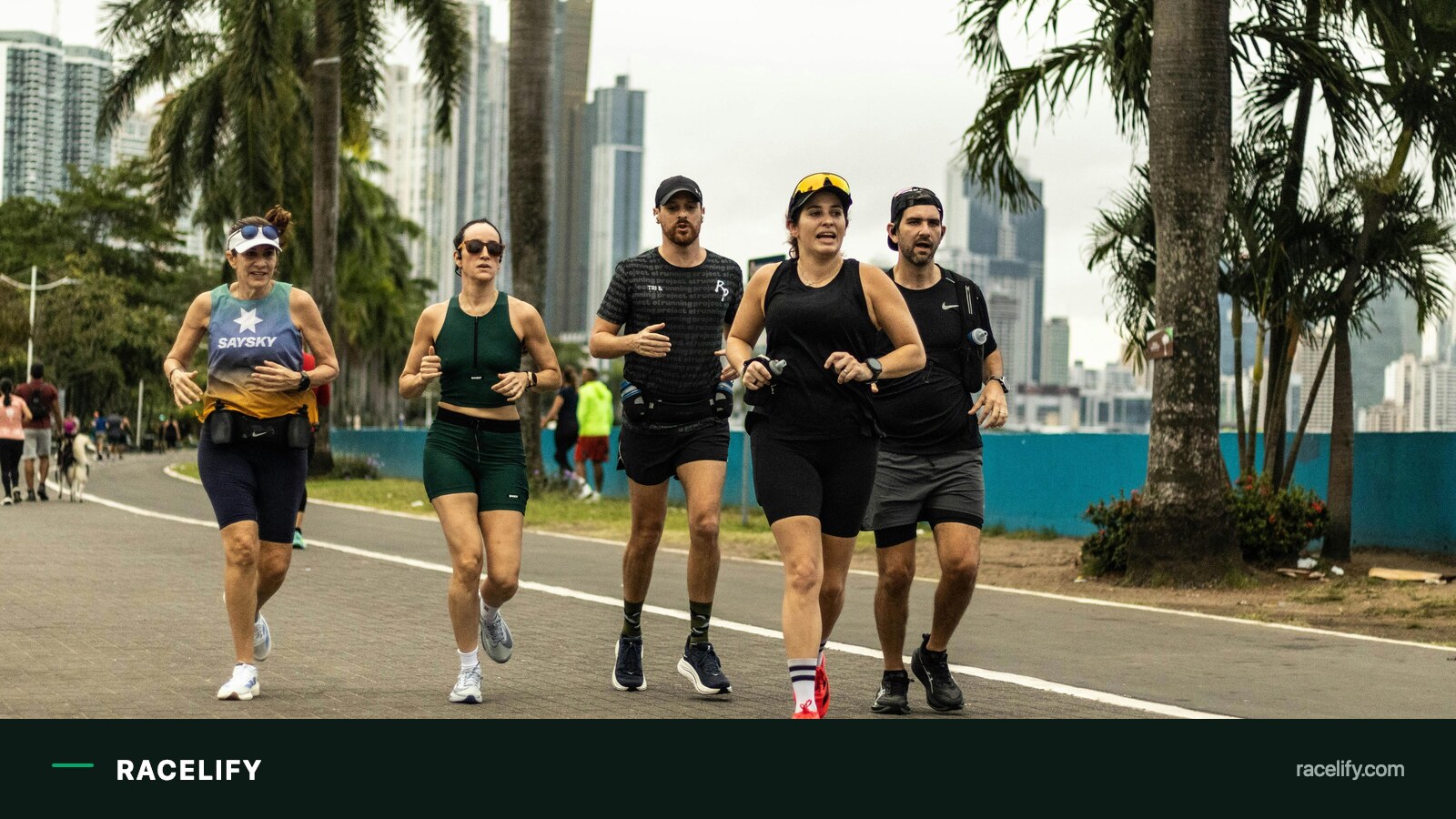 Runners training outdoors wearing GPS watches
