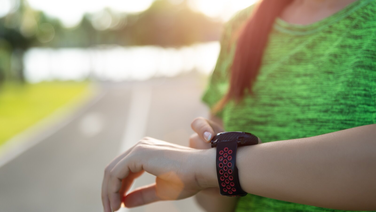 Runner checking a GPS sports watch mid-run