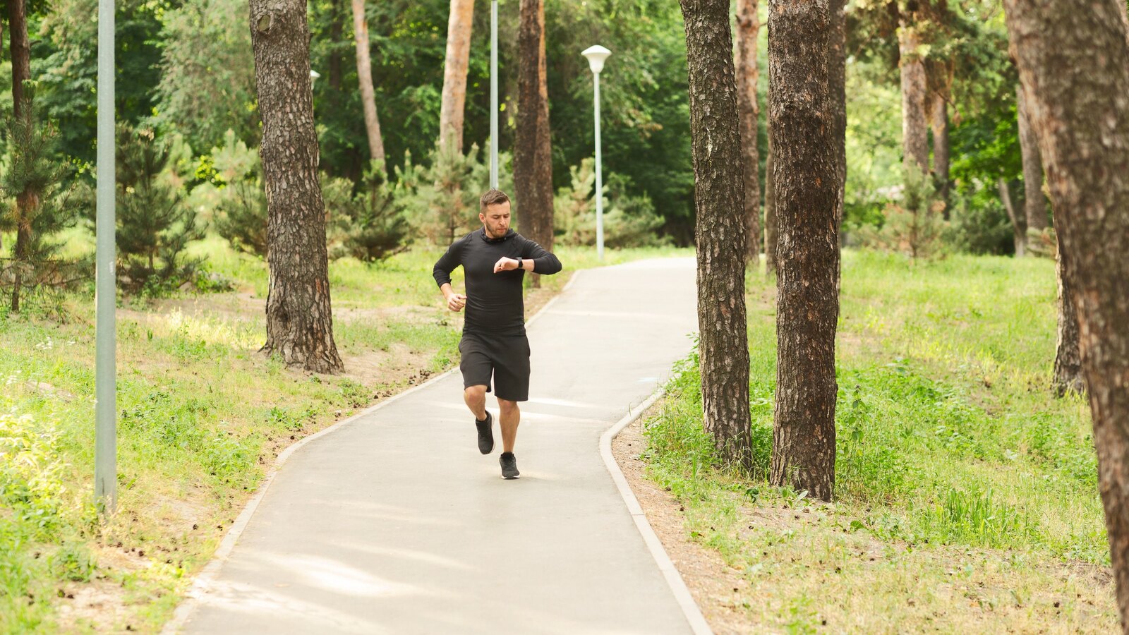 Runner on a tree-lined path where GPS signal is hardest to hold