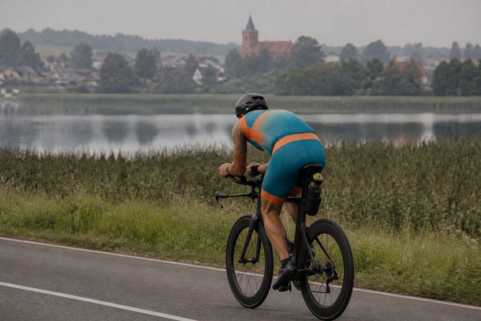 Cyclist checking a power meter during a triathlon bike leg