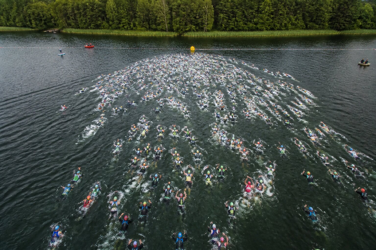 Triathletes treading water at a deep water swim start before a race