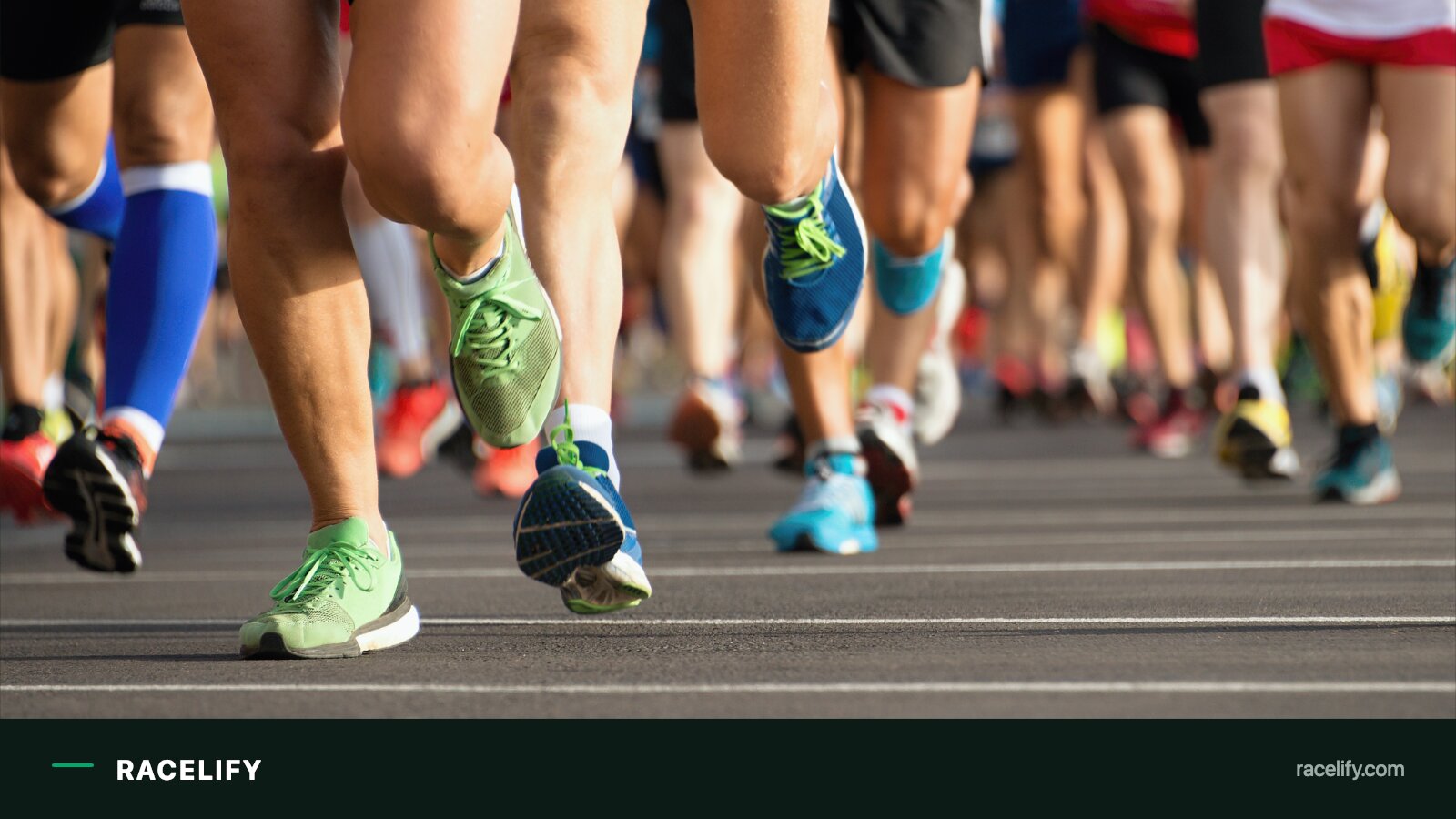 Elite marathon runners mid-stride on a city street course lined with spectators.