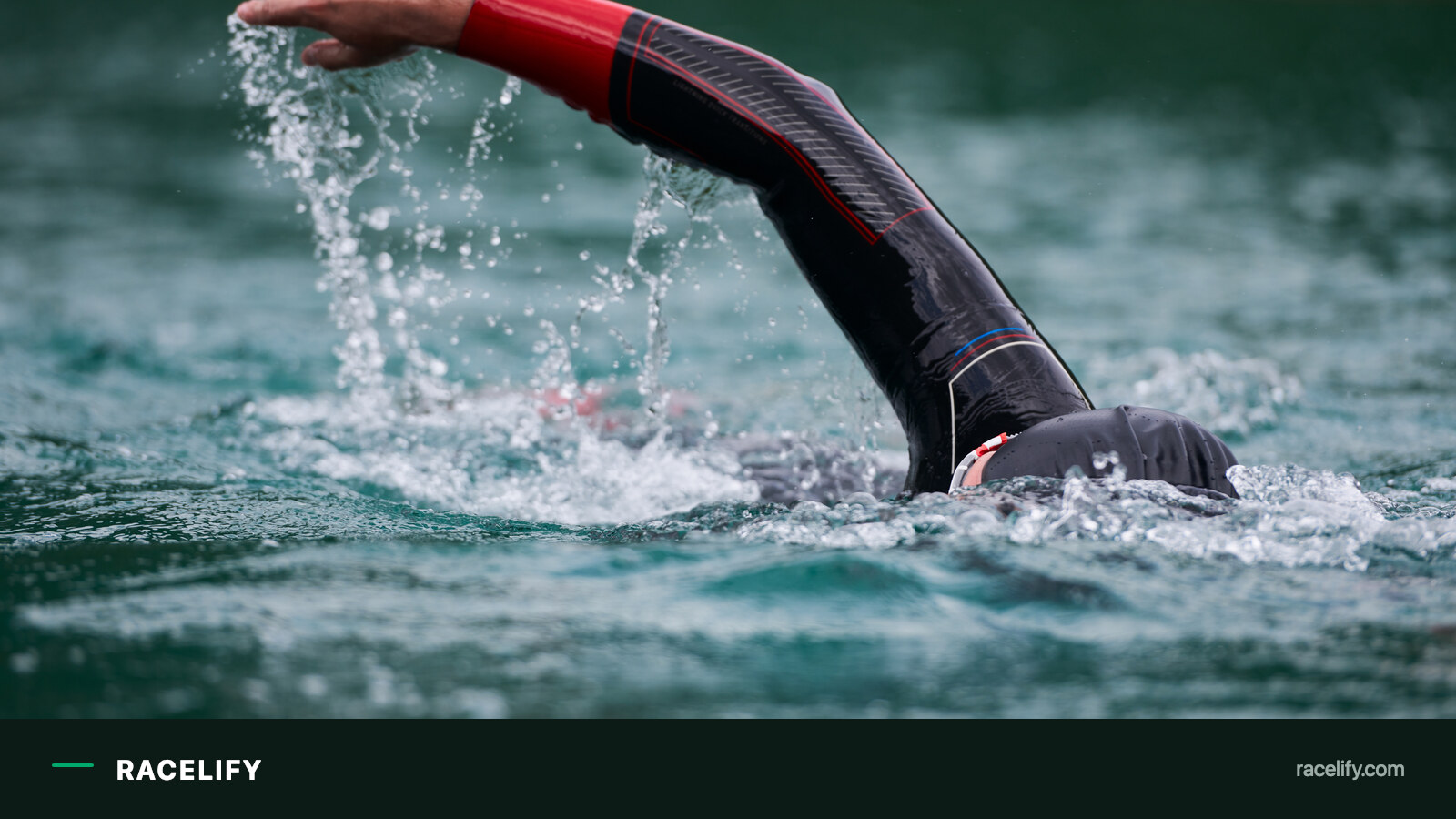 Swimmer in a wetsuit entering open water