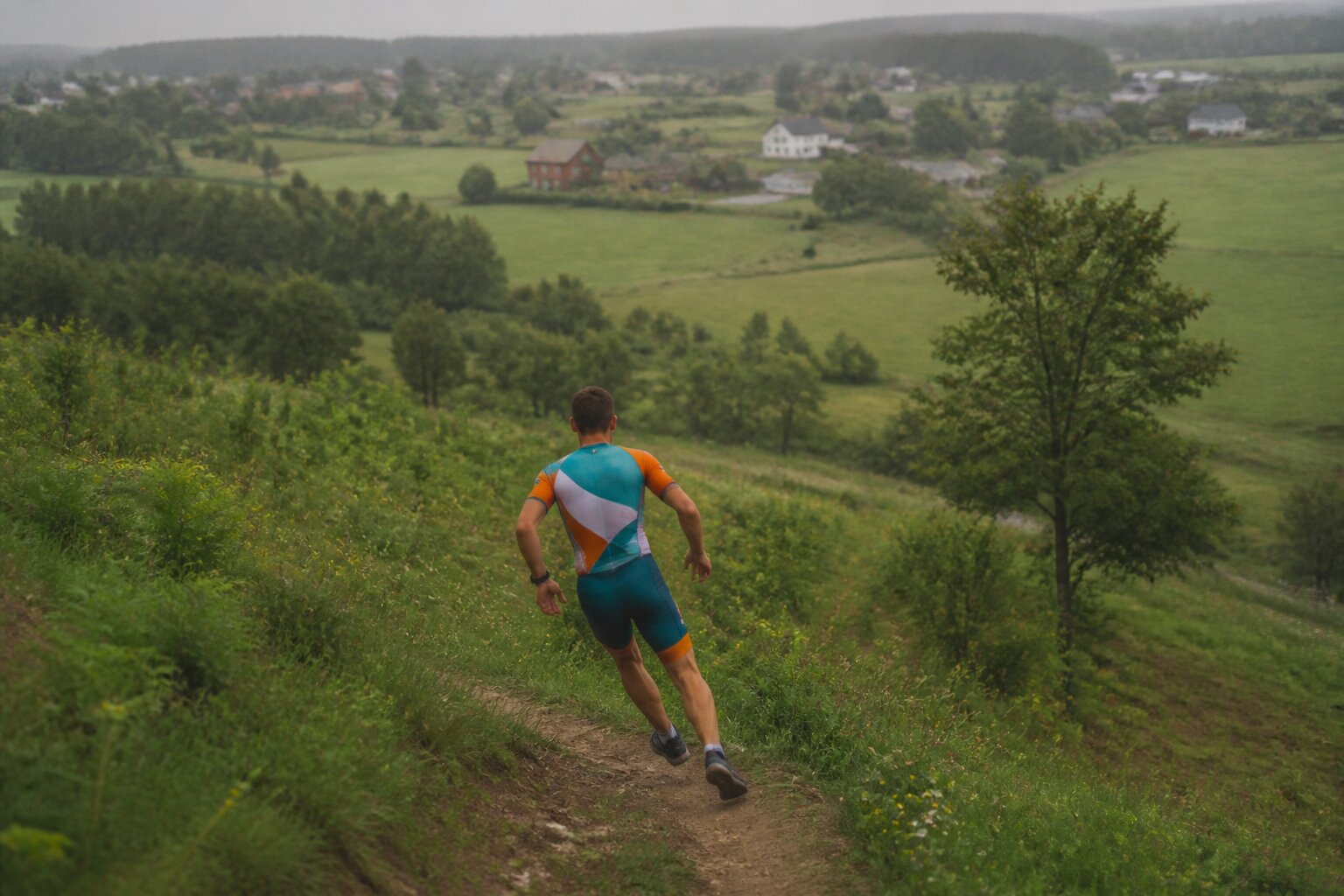 Runner descending a steep mountain trail